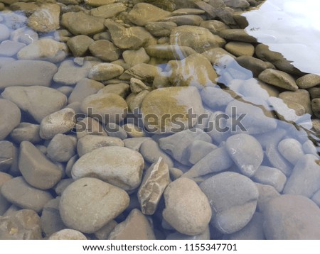 Pebbles under water background