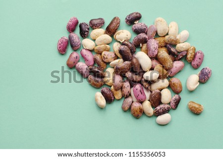 Collection set of various dried kidney legumes haricot beans close up isolated on blue background.  Healthy food. 