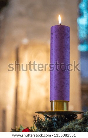 One candle flaming during Christmas at a Church
