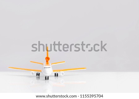 toy plane with orange wings, on a gray background