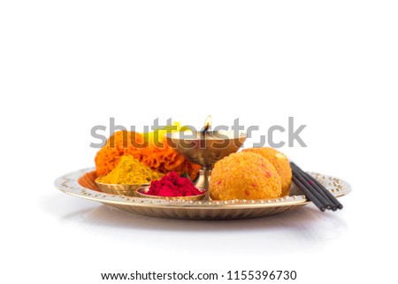 Beautifully Decorated Pooja Thali for festival celebration to worship, haldi or turmeric powder and kumkum, flowers, scented sticks in brass plate, hindu puja thali Royalty-Free Stock Photo #1155396730