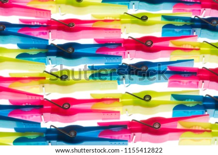 Composition of horizontal colored clothespins white isolated
