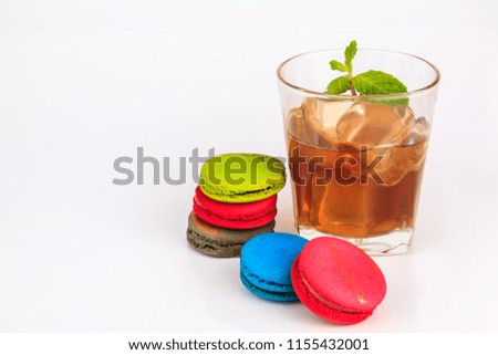 Colorful macarons cakes with and cup tea Isolated on white background.
