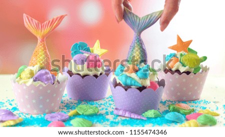 Mermaid theme cupcakes with colorful glitter tails, shells and sea creatures toppers for children's, teen's, novelty birthday and party celebrations.