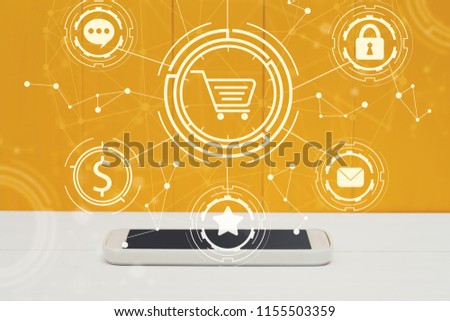Online shopping theme  with smartphone on yellow wooden background