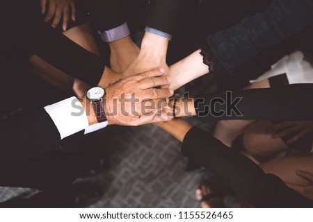 Multi ethic team work concept. Business man and woman putting hands together. Topdown view shor. Royalty-Free Stock Photo #1155526465