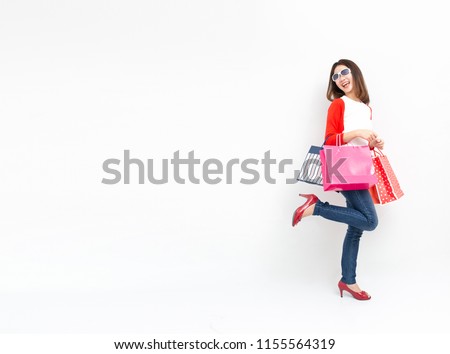A smiling women holding shopping bag on the white background.
