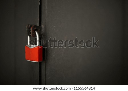 A red lock on the iron door 