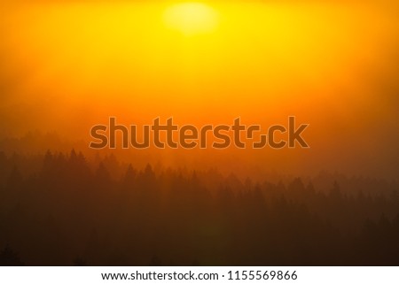 Smoke from the summer 2018 California wildfires glows under the setting sun Royalty-Free Stock Photo #1155569866