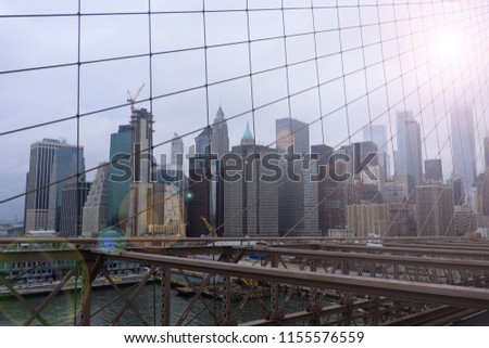 New York city view pass trough the spider cabel  of Brooklyn bridge with lighting effect.