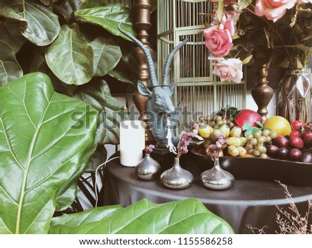 Interior decoration candle light, flower, fruits and flower bouquet home vintage. (Selective focus)