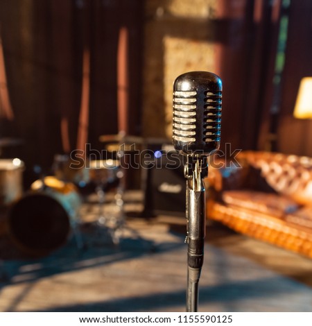 sound retro microphone in recording studio on interior background
