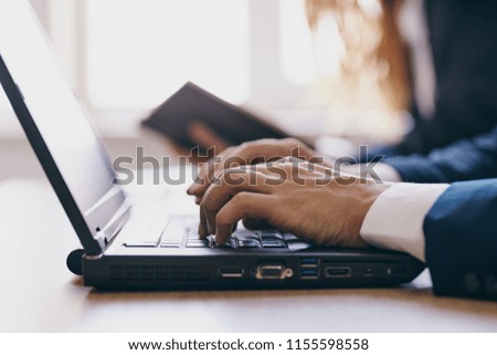 typing on laptop keyboard business office                              
