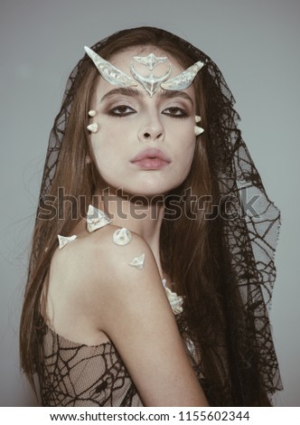 Mystic fairy tail character. Woman with horns and thorns wears black veil fantasy creature. Girl with fantasy style make up. Halloween ideas concept. Girl with thorns as devil dragon magical creature.