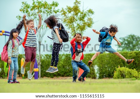 kids preschool kindergarten enjoy and happy jumping on the field of playground after school class is over to retuning home Royalty-Free Stock Photo #1155615115