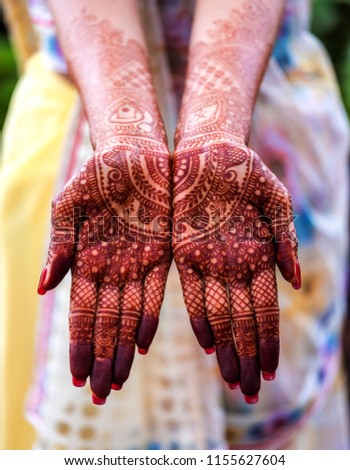 Indian bride showing mehndi tattoos design Royalty-Free Stock Photo #1155627604