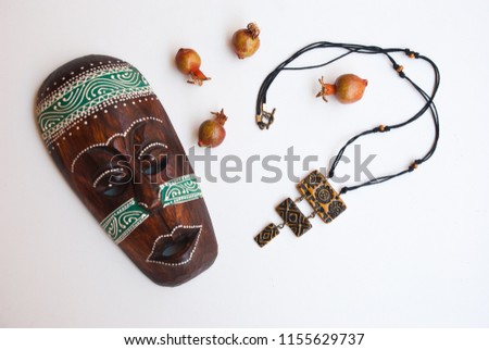 Tribal african long necklace with mask. Handmade jewelry of polymer clay. Fashion background.