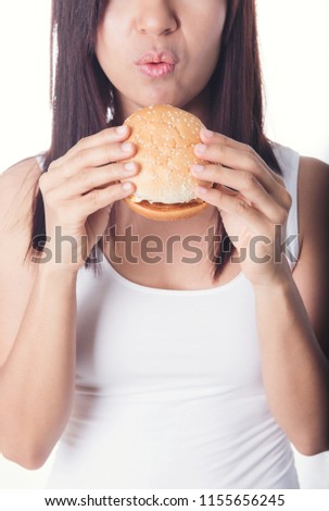 beauty asian women eating burger isolated on white background. fast food to fat. Healthy junk food Concept.