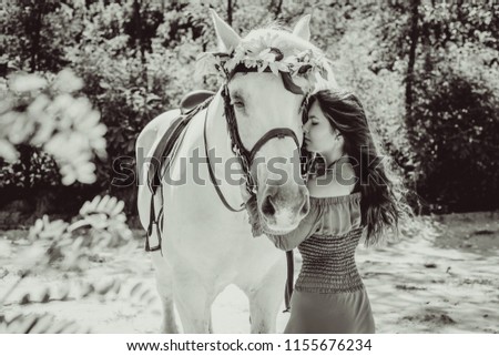 Romantic scene woman with a horse in the countryside. Concept of horse and human. Portrait of vintage style artistic woman walking with horse outdoors 