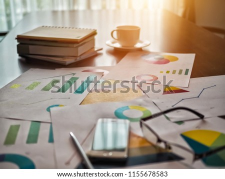 business paper graph and accessory on desk table