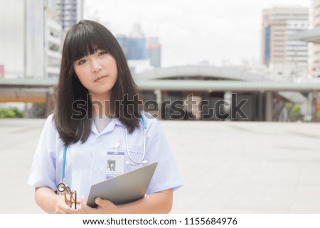 woman Asian doctor  White Shirt suit with stethoscope working outdoor Hospital.