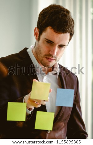 Handsome young caucasian businessman in modern office.
