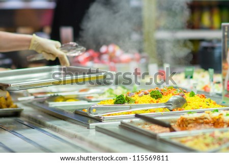 Salads and other dishes with vegetables and meat on table in restaurant