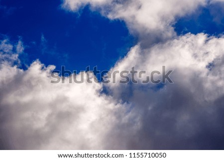 dense and great white clouds on a beautiful sunny summer blue sky