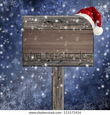 wooden sign with Santa hat on snowy background