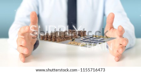 View of a Businessman holding a Supply Chain title with a warehouse on background 3d rendering