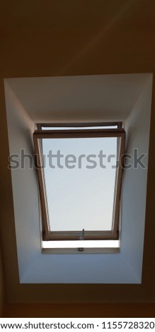 open mansard window made of natural light wood