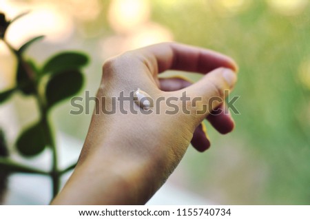 
A drop of tonal basis or bb cream on the hand Royalty-Free Stock Photo #1155740734