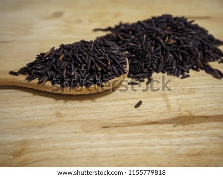 black rice on spoon wood