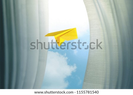 Travel, Freedom and Imagination Concept. Paper Airplanes Flying Through Window and Curtain, Selective Focus. Blue Sky as Outside View