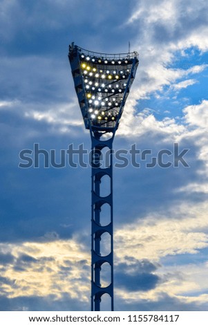Floodlight poles in a sports stadium in the evening