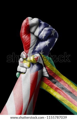 AMERICAN VS Zimbabwe, Fist painted in colors of Zimbabwe flag, fist flag, country of Zimbabwe