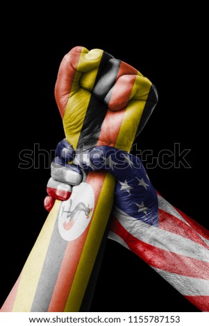 AMERICAN VS Uganda, Fist painted in colors of Uganda flag, fist flag, country of Uganda