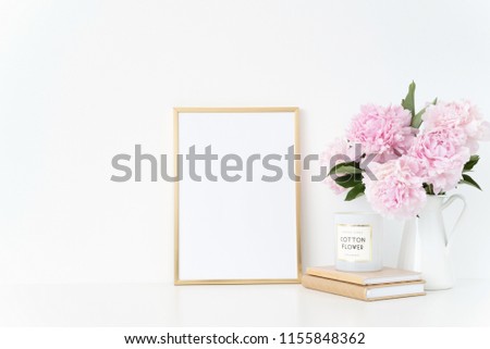 Elegant gold portrait a4 frame mock up with a pink peonies in white jug. Overlay your quote, promotion, headline, or design, great for small businesses, lifestyle bloggers and social media campaigns