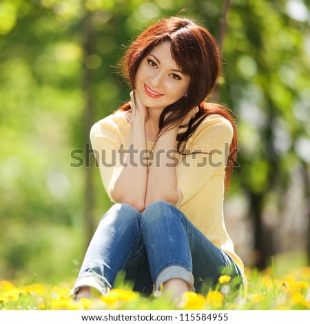 Young woman in the park with flowers