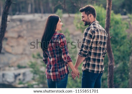 Always everywhere together forever! Rear behind view photo portrait of sweetheart charming perfect peaceful cute in casual clothes hipsters holding hands going taking steps in green wood look in eyes