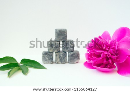 Beautiful pink peony flower with stone pyramid, green leaf, Zen and balance, relax picture