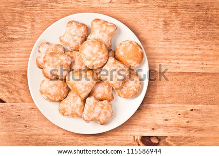 Polish ginger cookies on a plate on wooden background
