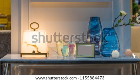 Modern Golden picture frame Table lamp Flower in vase glass bottle on marble table in living room interior decoration
