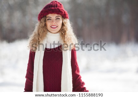 Close up portrait of young beautiful woman on winter background