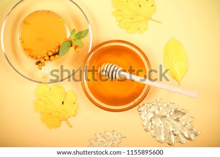 tea from sea buckthorn honey oranges berries lie on a table
