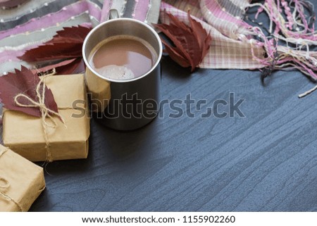 Autumn composition. Hot chocolate, gifts, scarf on a black background. Flat lay, top view, copy space