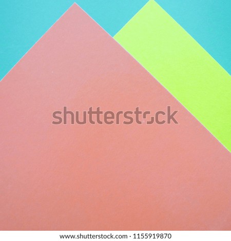 Modern flat lay background with color paper sheets. Green, pink and blue.