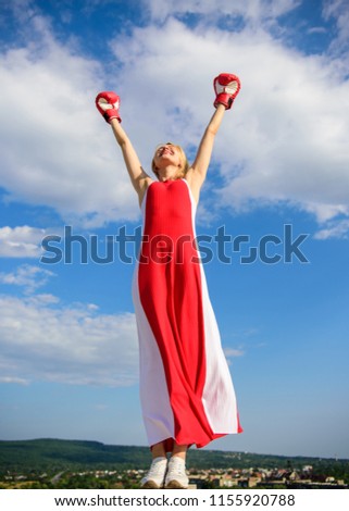 Femininity and strength balance. Woman red dress and boxing gloves enjoy victory. She fighter female rights. Lady fighter enjoy celebrate victory. Satisfied free girl boxing gloves. Winner concept.