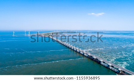 Oosterschelde flood barrier with windmills in the Netherlands at the Northern Sea taken from above with a drone Royalty-Free Stock Photo #1155936895