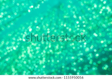 Abstract green bokeh circles for Christmas background. Royalty high-quality free stock photo of Christmas light overlay background. Holiday glowing backdrop. Defocused background with blinking stars